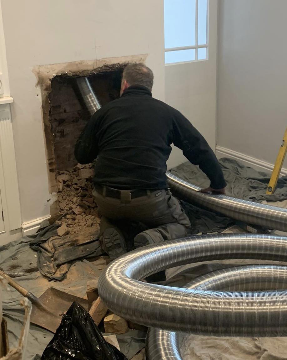 a wood burning stove being installed by a HETAS registered installer